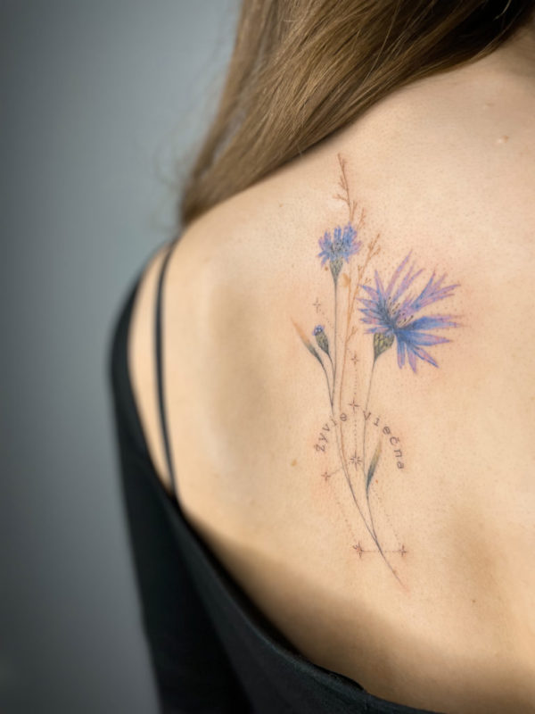 Cornflower tattoo on the right side of the neck.